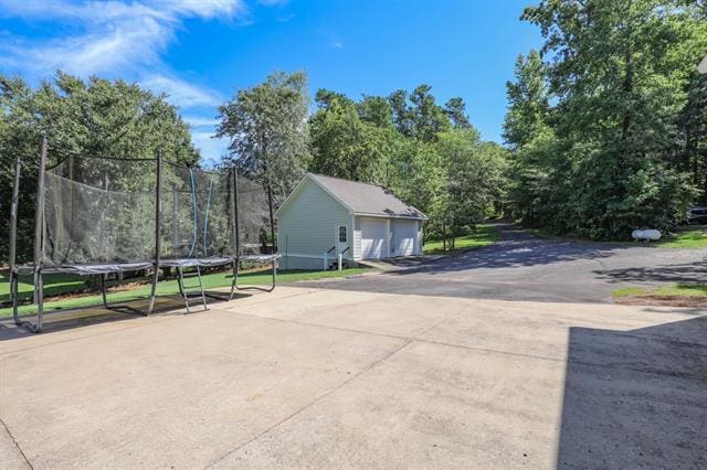 exterior space featuring a trampoline and a garage