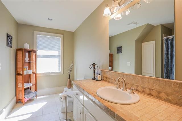 full bath with decorative backsplash, visible vents, vanity, and tile patterned flooring