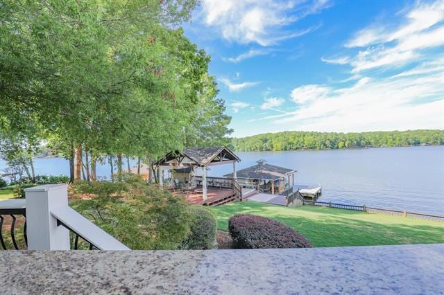 dock area with a water view and boat lift