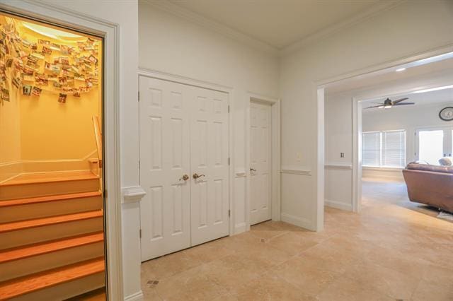 corridor with stairway, baseboards, and ornamental molding