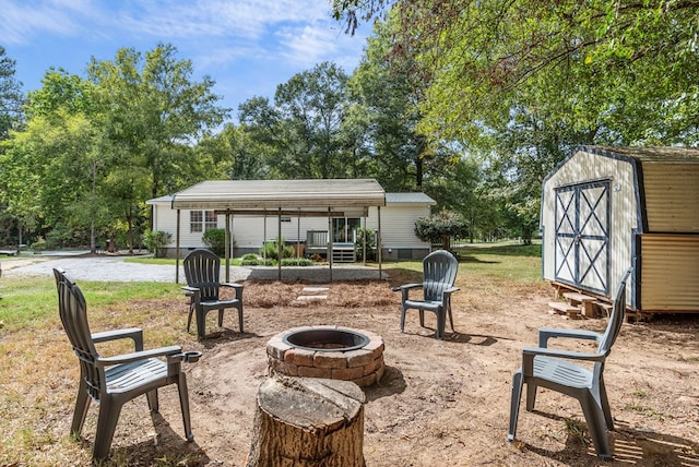 view of patio / terrace with a fire pit and a storage unit