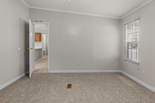 carpeted empty room with ornamental molding