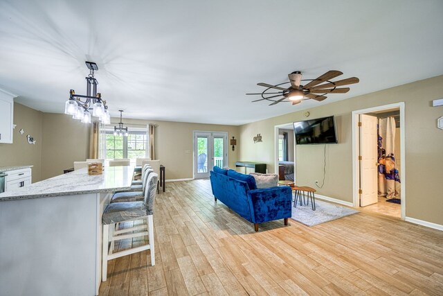 154 Old Plantation Trl, Milledgeville, GA 31061 - living area with a chandelier, light wood-type flooring, baseboards, and a ceiling fan
