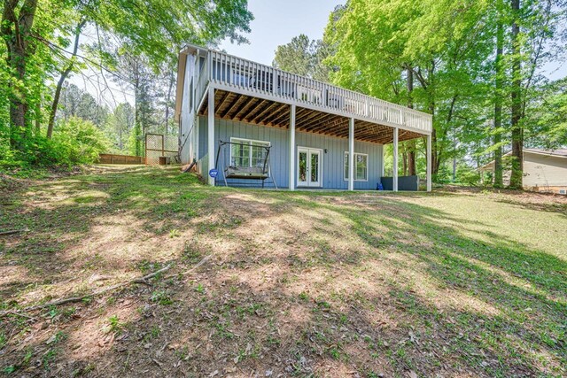 154 Old Plantation Trl, Milledgeville, GA 31061 - rear view of house with french doors, a deck, board and batten siding, and a yard