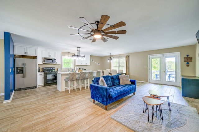 154 Old Plantation Trl, Milledgeville, GA 31061 - living area with ceiling fan, light wood-style flooring, healthy amount of natural light, and a chandelier