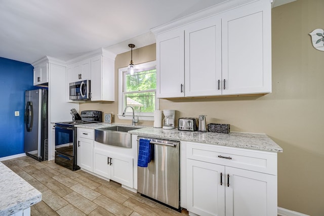 154 Old Plantation Trl, Milledgeville, GA 31061 - kitchen with appliances with stainless steel finishes, white cabinetry, baseboards, a sink, and light wood finished floors