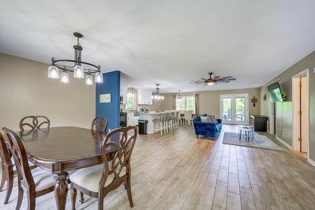 154 Old Plantation Trl, Milledgeville, GA 31061 - dining room featuring light wood-style floors, a chandelier, ceiling fan, and baseboards
