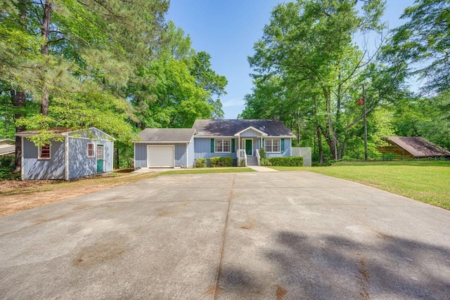 154 Old Plantation Trl, Milledgeville, GA 31061 - single story home with a garage, covered porch, a front lawn, concrete driveway, and an outbuilding