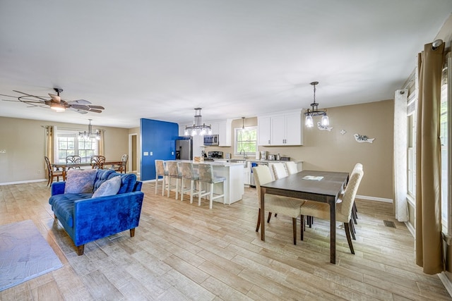 154 Old Plantation Trl, Milledgeville, GA 31061 - dining space with a chandelier, light wood-style flooring, healthy amount of natural light, and baseboards