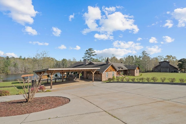 view of front of house with a carport and a water view