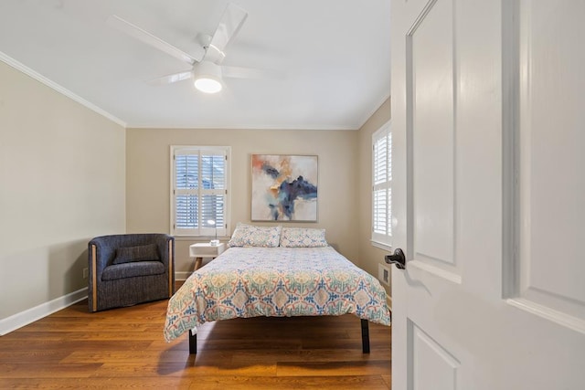 bedroom featuring hardwood / wood-style floors, ceiling fan, and crown molding