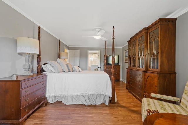 bedroom featuring hardwood / wood-style flooring, ceiling fan, and crown molding