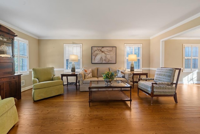 living area with dark hardwood / wood-style floors and ornamental molding