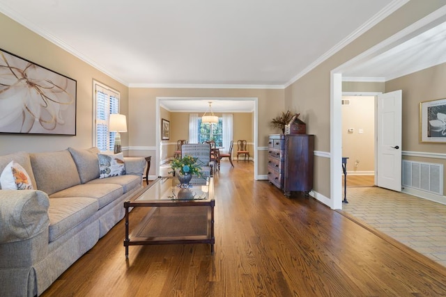 living room with crown molding and wood-type flooring