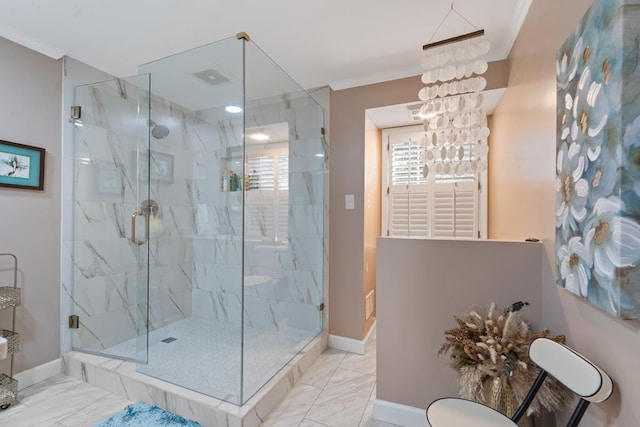 bathroom with plenty of natural light, crown molding, walk in shower, and an inviting chandelier