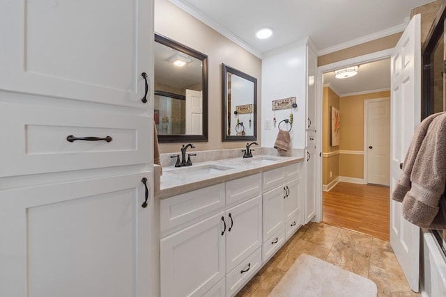 bathroom with wood-type flooring, vanity, a shower with door, and ornamental molding