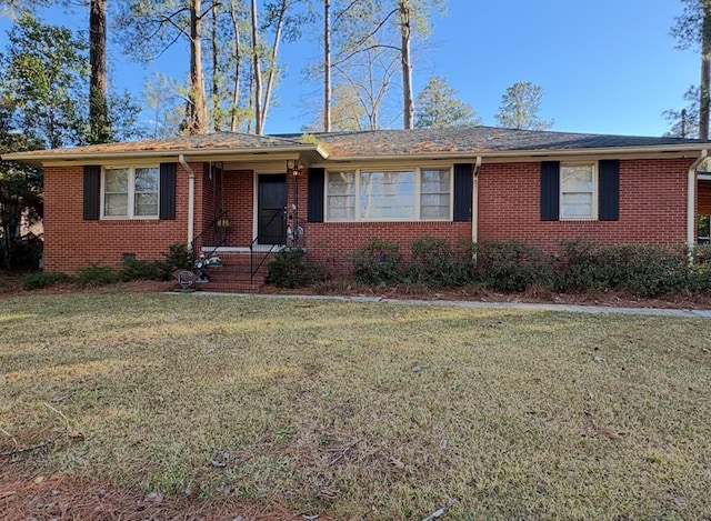 single story home with a front lawn and brick siding