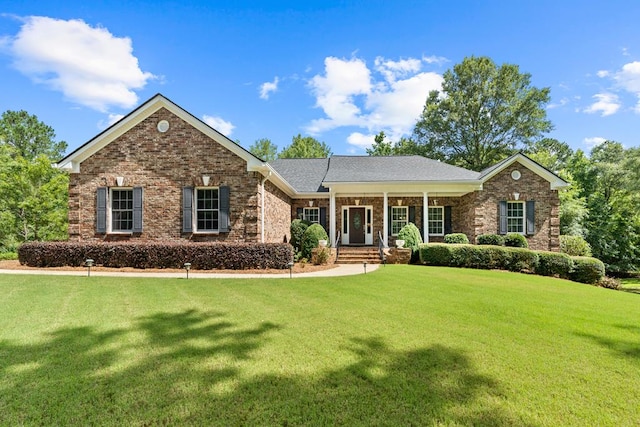 411 Rockville Rd, Eatonton, GA 31024 - view of front of house with a front lawn, covered porch, and brick siding