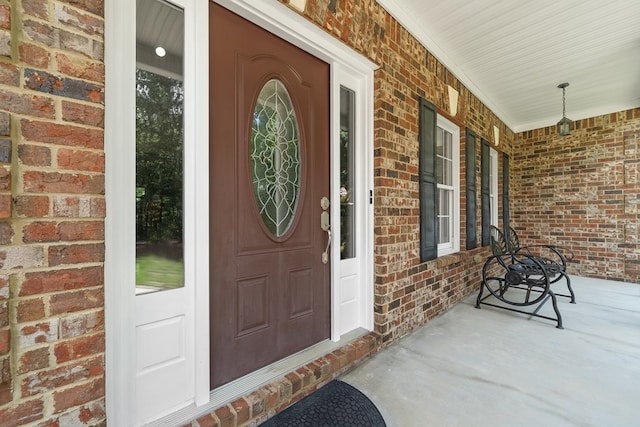 411 Rockville Rd, Eatonton, GA 31024 - view of exterior entry with a porch and brick siding