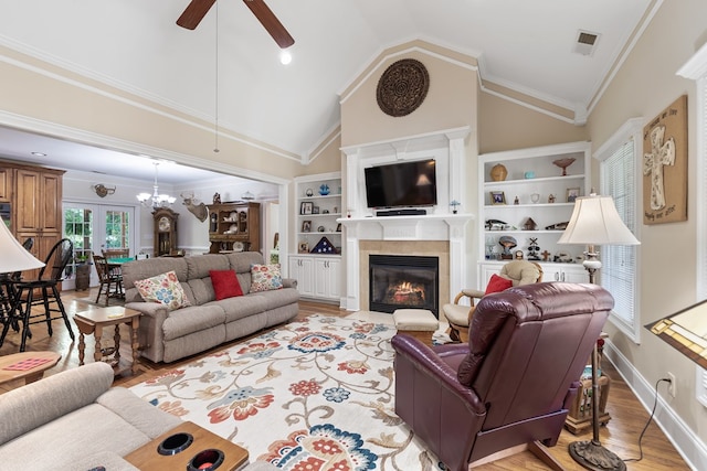 411 Rockville Rd, Eatonton, GA 31024 - living room with a ceiling fan, a fireplace with flush hearth, light wood-style flooring, built in features, and high vaulted ceiling