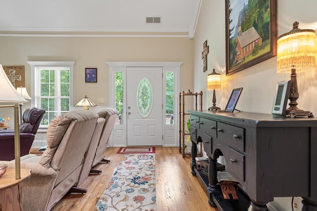 411 Rockville Rd, Eatonton, GA 31024 - foyer featuring crown molding, plenty of natural light, light wood-type flooring, and a chandelier