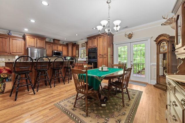411 Rockville Rd, Eatonton, GA 31024 - dining space with crown molding, a chandelier, recessed lighting, light wood-type flooring, and wainscoting