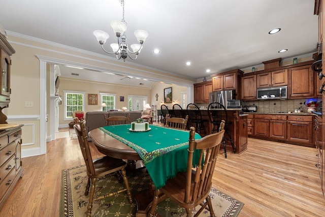 411 Rockville Rd, Eatonton, GA 31024 - dining area featuring ornamental molding, a chandelier, light wood-style flooring, a ceiling fan, and recessed lighting