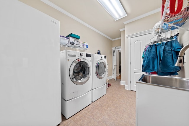 411 Rockville Rd, Eatonton, GA 31024 - laundry room featuring washer and dryer, crown molding, and light tile patterned floors