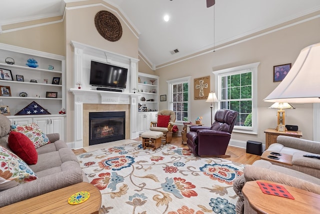 411 Rockville Rd, Eatonton, GA 31024 - living room with a fireplace, wood finished floors, ornamental molding, built in features, and a ceiling fan