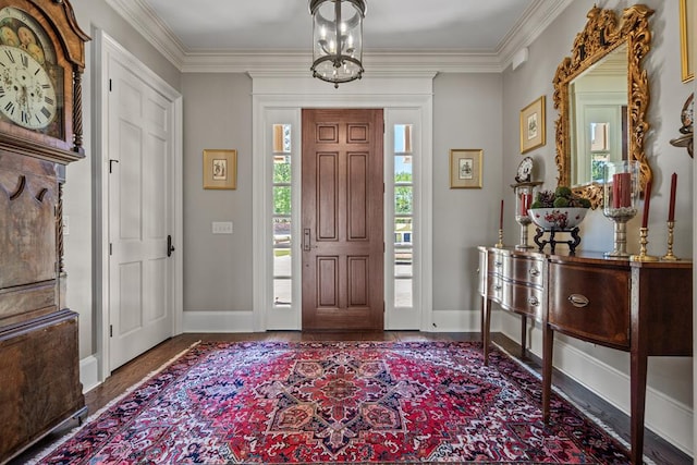 foyer entrance featuring ornamental molding and a notable chandelier
