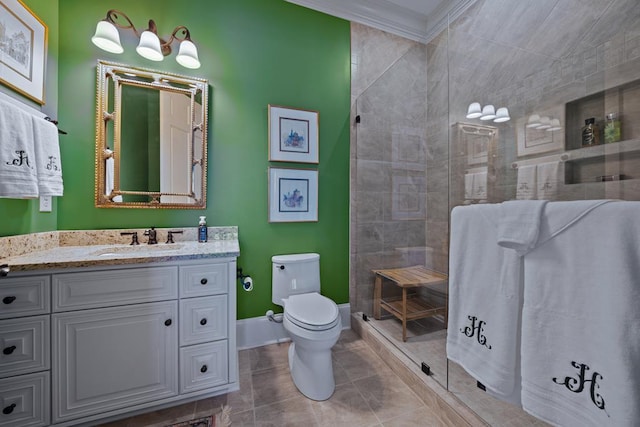 bathroom featuring vanity, a shower with door, tile patterned floors, toilet, and ornamental molding
