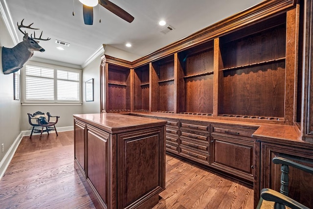 walk in closet with ceiling fan and light hardwood / wood-style flooring