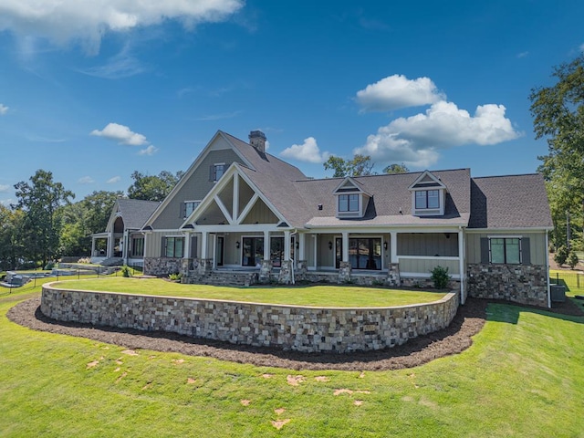 back of property featuring a lawn