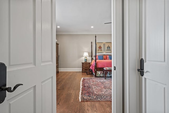 bedroom featuring hardwood / wood-style flooring and crown molding