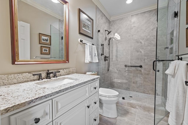 bathroom with vanity, toilet, a shower with door, and crown molding