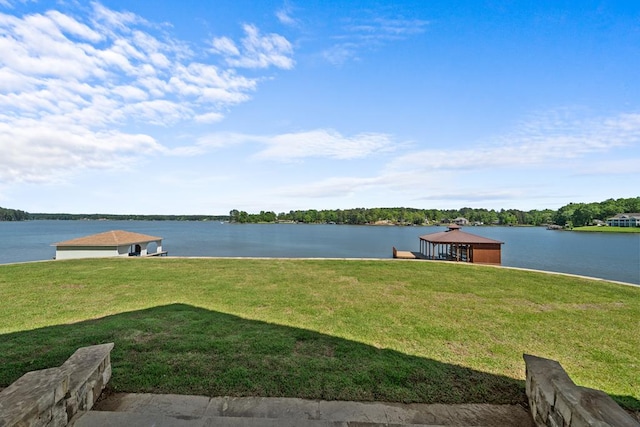 view of dock featuring a water view and a yard