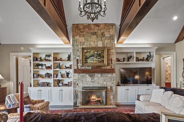 living room with a stone fireplace, beamed ceiling, and an inviting chandelier