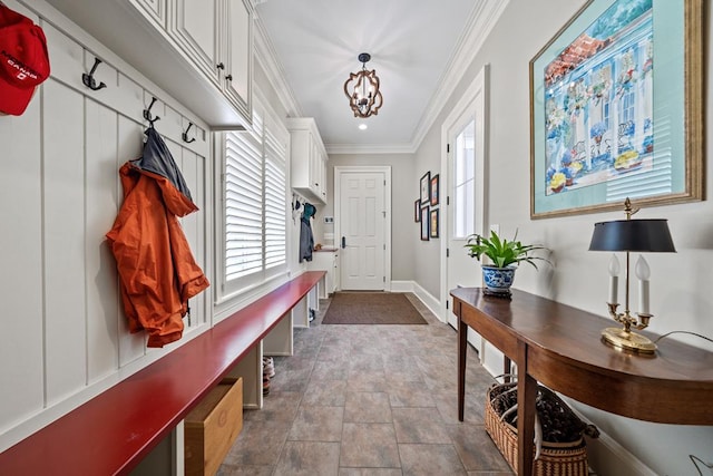 mudroom with ornamental molding and a notable chandelier
