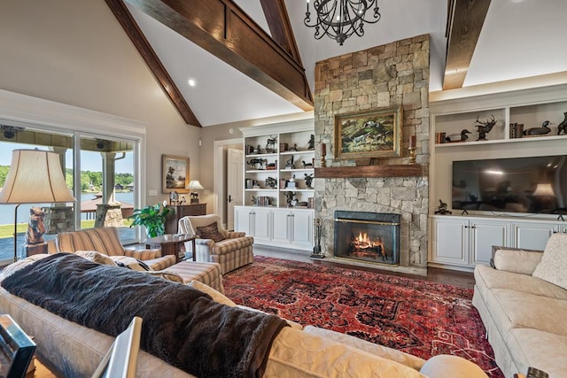 living room featuring a fireplace, beam ceiling, high vaulted ceiling, and built in features
