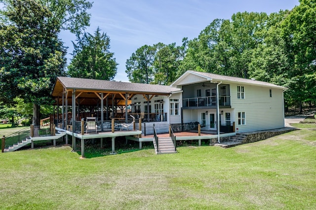 back of property featuring french doors, a yard, and a wooden deck