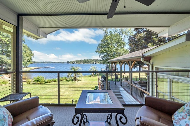 balcony with ceiling fan and a water view