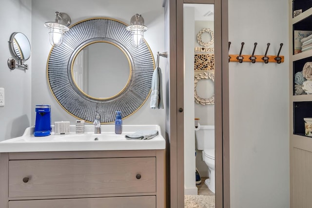 bathroom featuring vanity and toilet