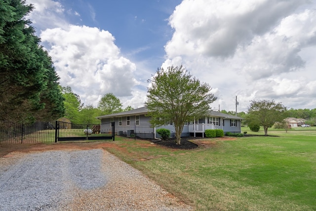 220 Pitts Chapel Rd, Newborn, GA 30056 - view of front of house with a gate, gravel driveway, a front lawn, and fence