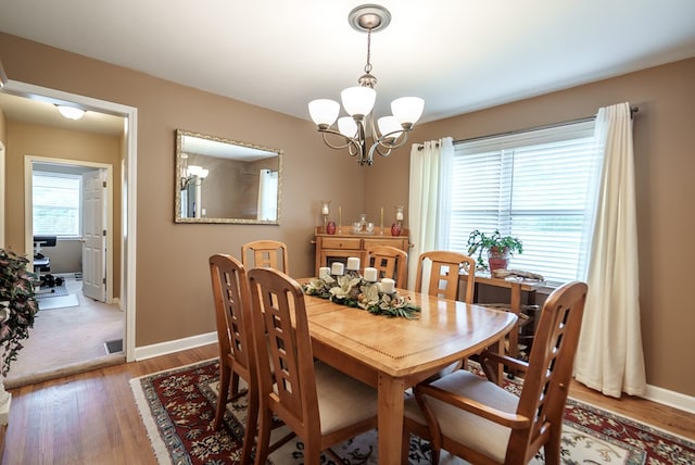 220 Pitts Chapel Rd, Newborn, GA 30056 - dining space featuring baseboards, wood finished floors, and a notable chandelier