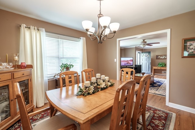 220 Pitts Chapel Rd, Newborn, GA 30056 - dining space featuring light wood finished floors, baseboards, and ceiling fan with notable chandelier