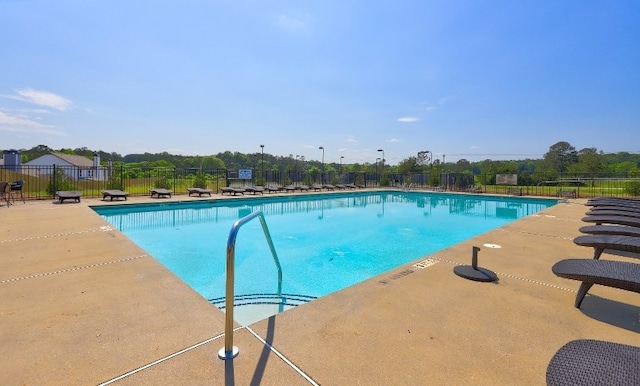 pool featuring a patio and fence
