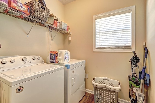 laundry area featuring laundry area, baseboards, dark wood-style floors, and washing machine and clothes dryer