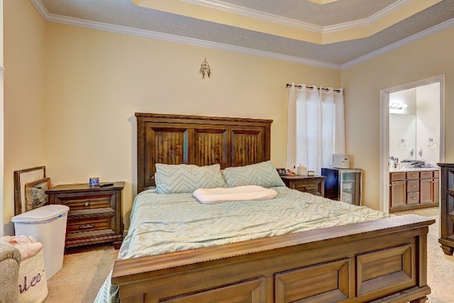 bedroom with crown molding, a raised ceiling, connected bathroom, and light colored carpet