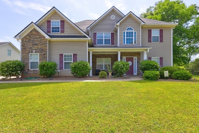view of front of home with a front yard and stone siding