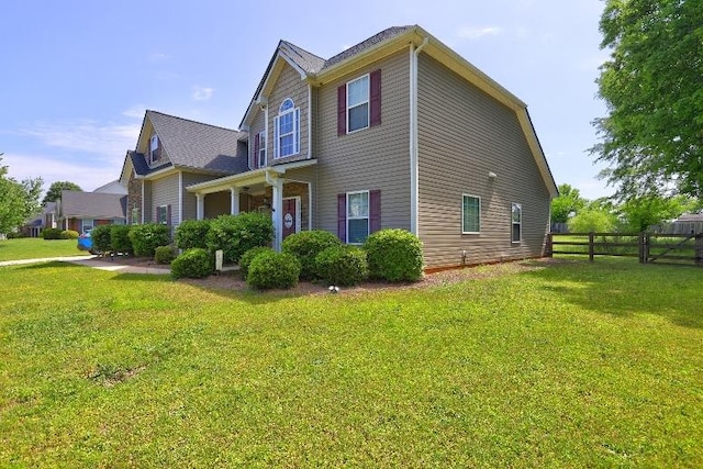 view of property exterior with fence and a yard